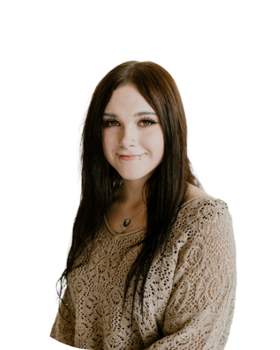 A young woman with long dark hair and a beige lace top is smiling slightly, posed against a plain white background.