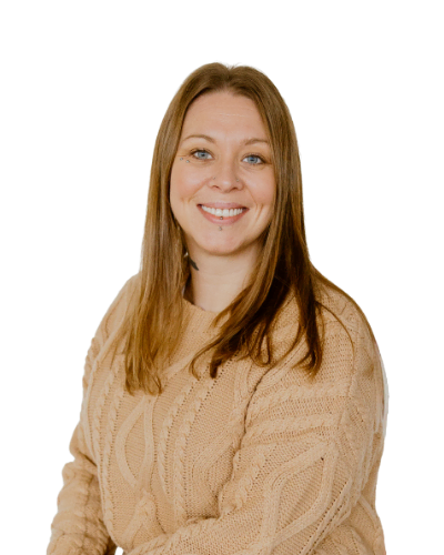 Woman with straight light brown hair wearing a beige cable-knit sweater, smiling, seated against a plain white background.